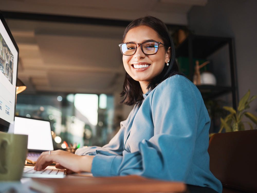 Woman working on her computer in office at night